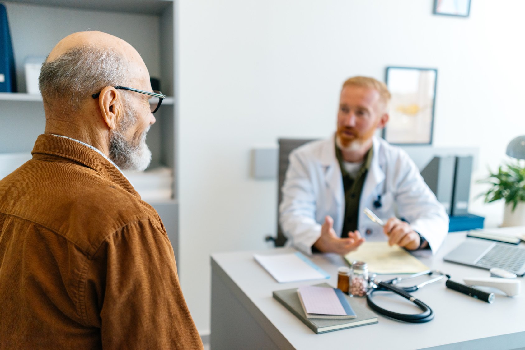 Health worker taking a blood sample from a smiling patient in a modern clinic